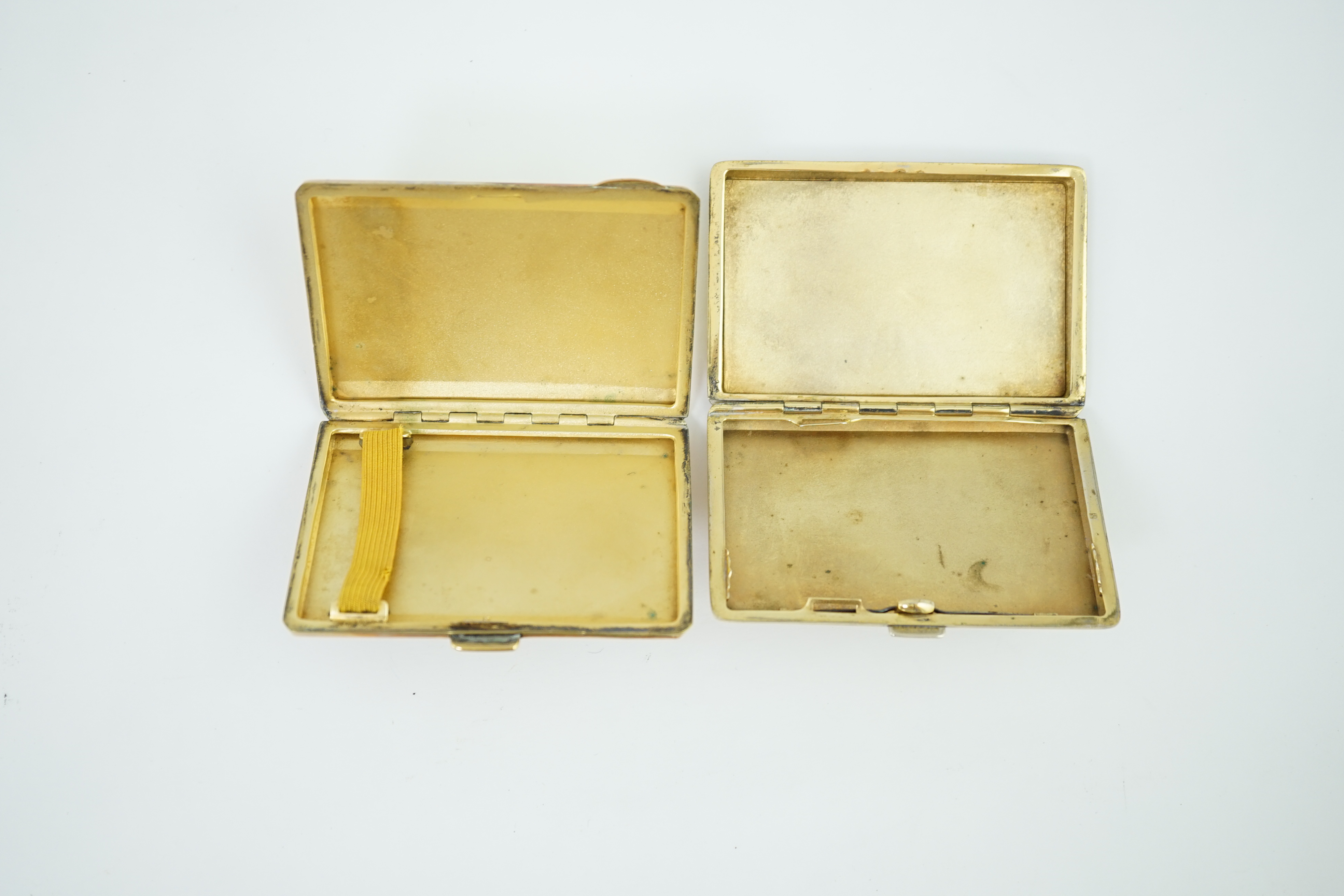 Two early 20th century enamelled white and gilt metal cigarette cases and a snuff box